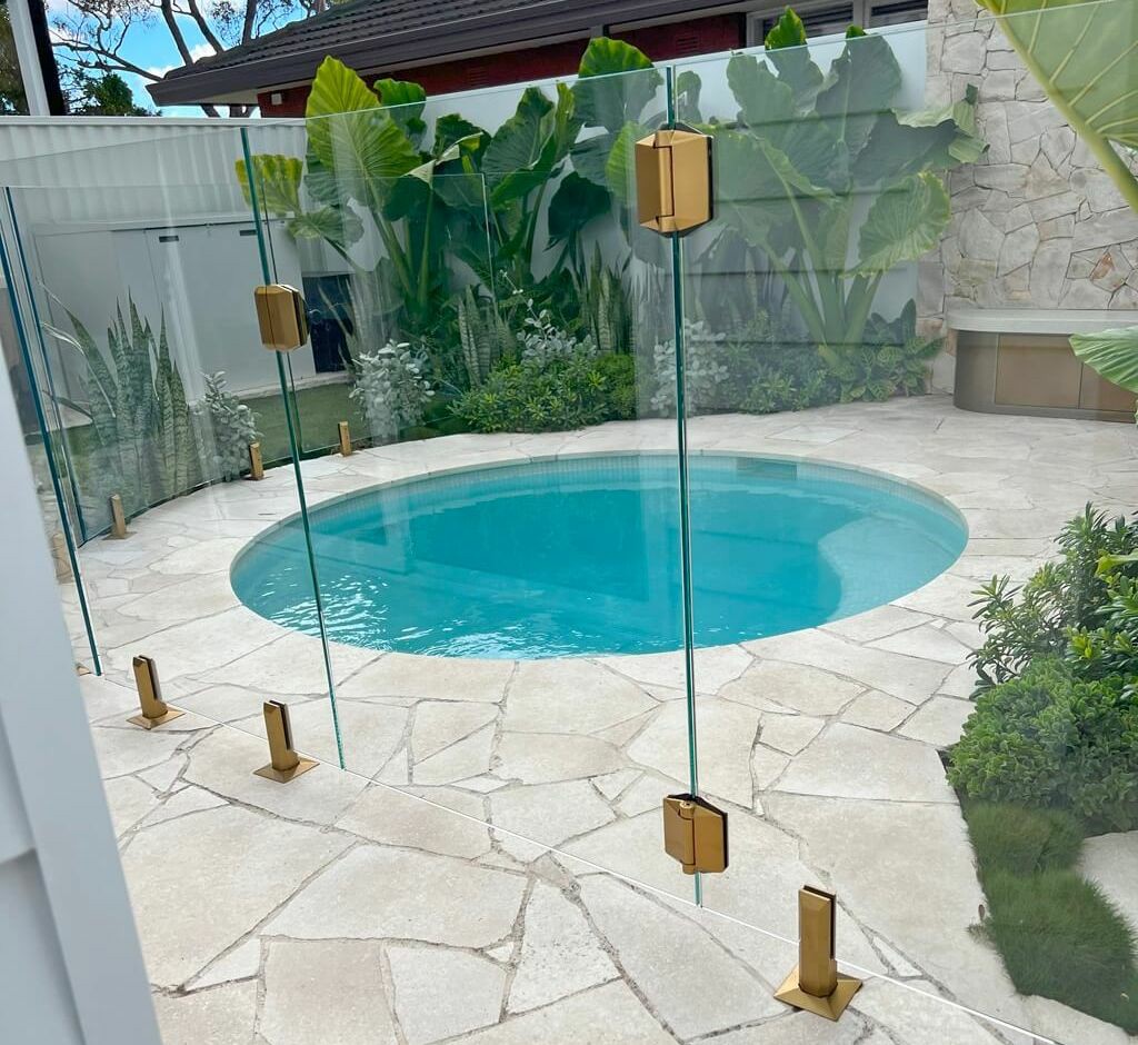 Glass pool gate surrounding a suburban swimming pool